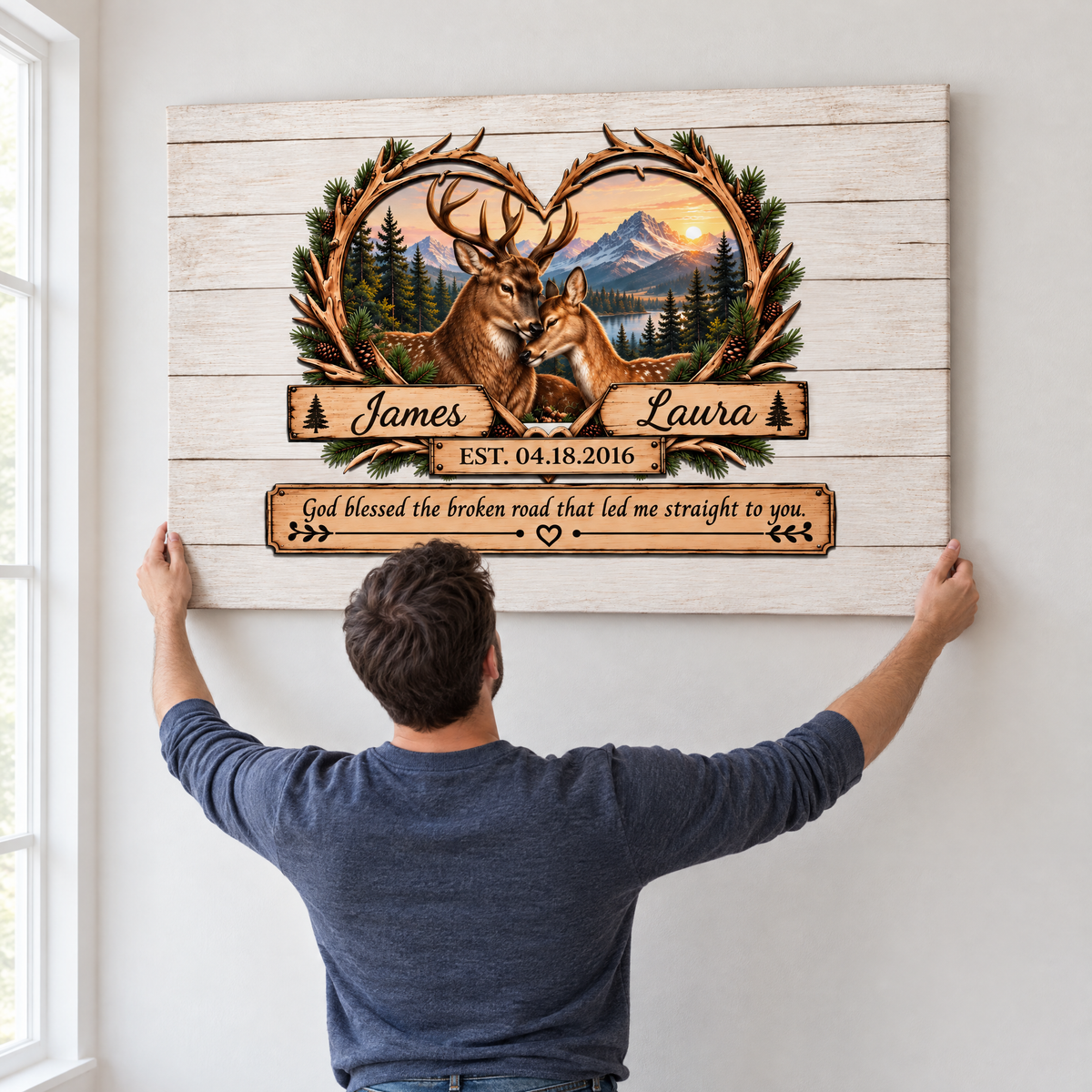 Man hanging the large deer couple canvas on a wall